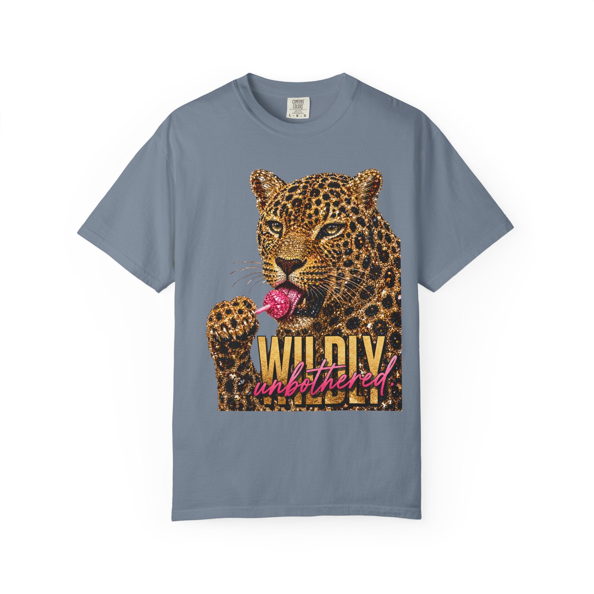 A blue jean color crewneck t-shirt featuring a graphic print of a leopard licking a pink lollipop on its tongue and the text 'WILDY unbothered' in gold and pink script.