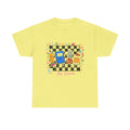 A cornsilk short-sleeve crewneck t-shirt featuring a colorful retro-themed graphic on the chest. The graphic depicts a black and white checkerboard background with various cartoon school supplies, a blue notebook device, a yellow pencil, scissors, glue bottle and the text 'Ms. Smith'