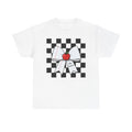 A white short-sleeve crewneck t-shirt featuring a graphic print of a black and white checkered square background with a white lined paper bow and a red apple at the center.