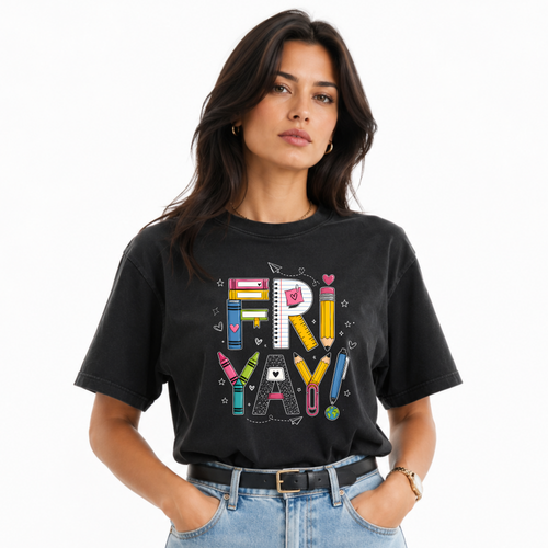 A woman wearing a black graphic t-shirt with a colorful 'FRI-YAY' letter design featuring school supplies, paired with light blue jeans, against a plain white background.