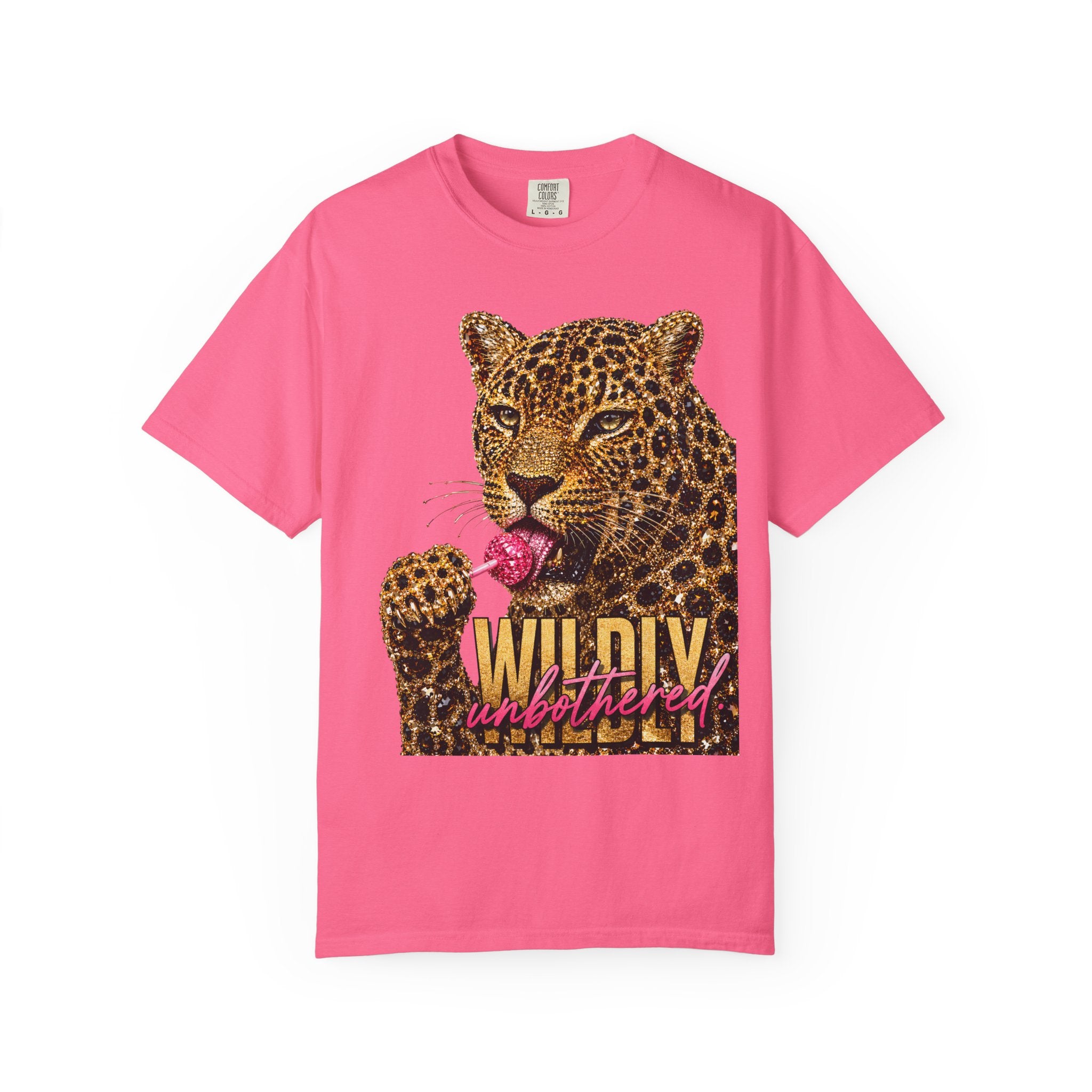 A bright pink, crunch berry, short-sleeve t-shirt featuring a graphic print of a leopard licking a pink lollipop with the text 'WILDLY unbothered' on the front, displayed against a solid white background.