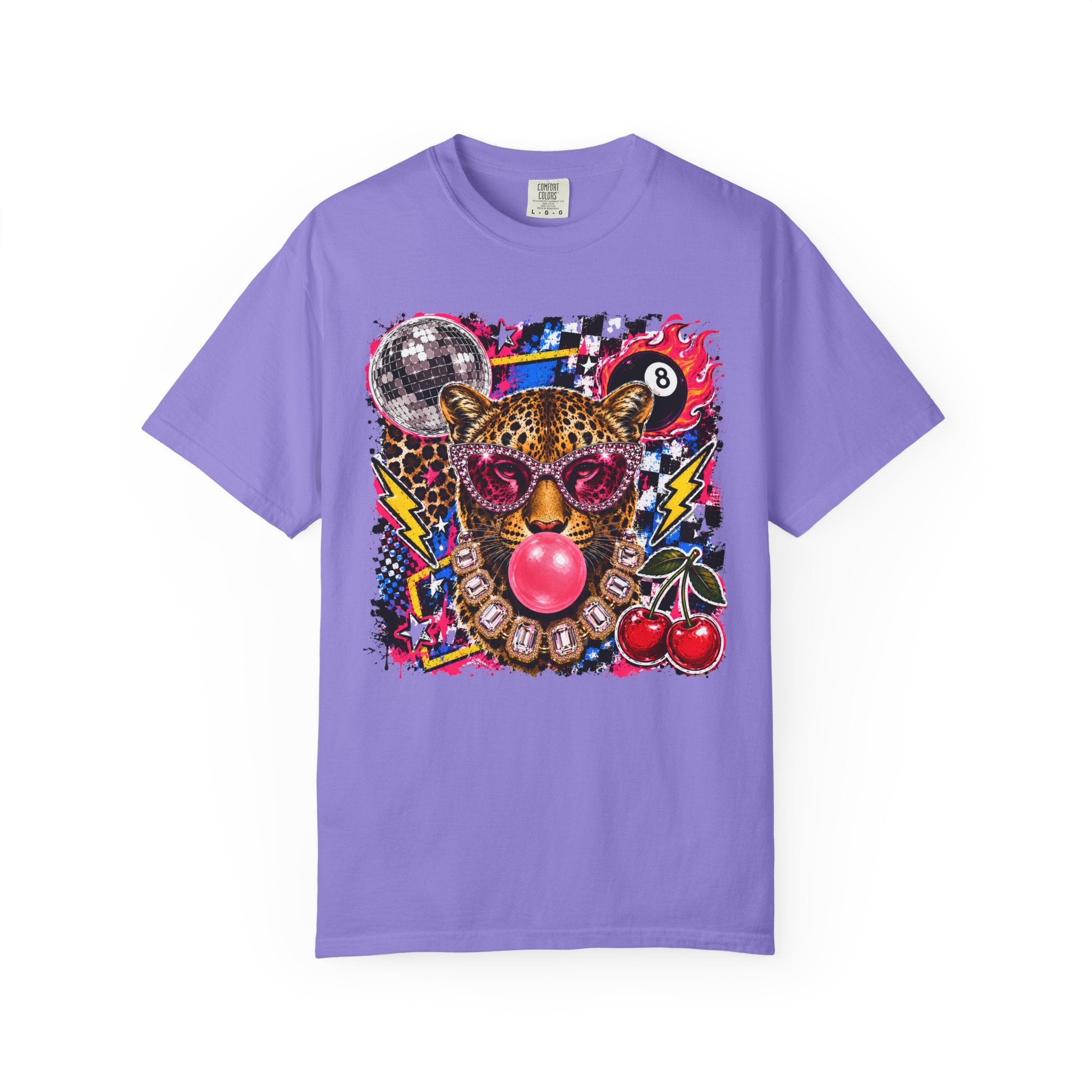 A violet short-sleeve crewneck t-shirt featuring a vibrant, multicolored graphic print of a leopard wearing pink sunglasses and blowing a pink bubblegum bubble, surrounded by cherries, a disco ball, and lightning bolts.