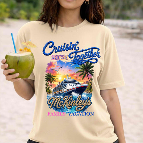 Person wearing a 'Cruisin' Together 2026 McKinley's Family Vacation' t-shirt on a beach.